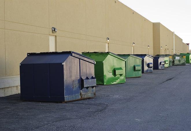 a group of construction workers taking a break near a dumpster in Arlington